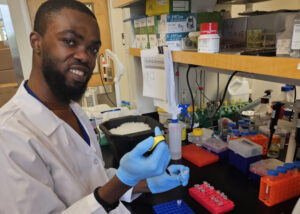 Bright Agbodzi (PhD candidate) pipetting reagents and getting ready to start a RT-PCR